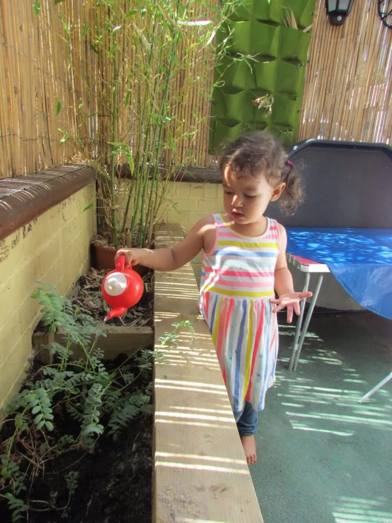 watering a flower in our garden